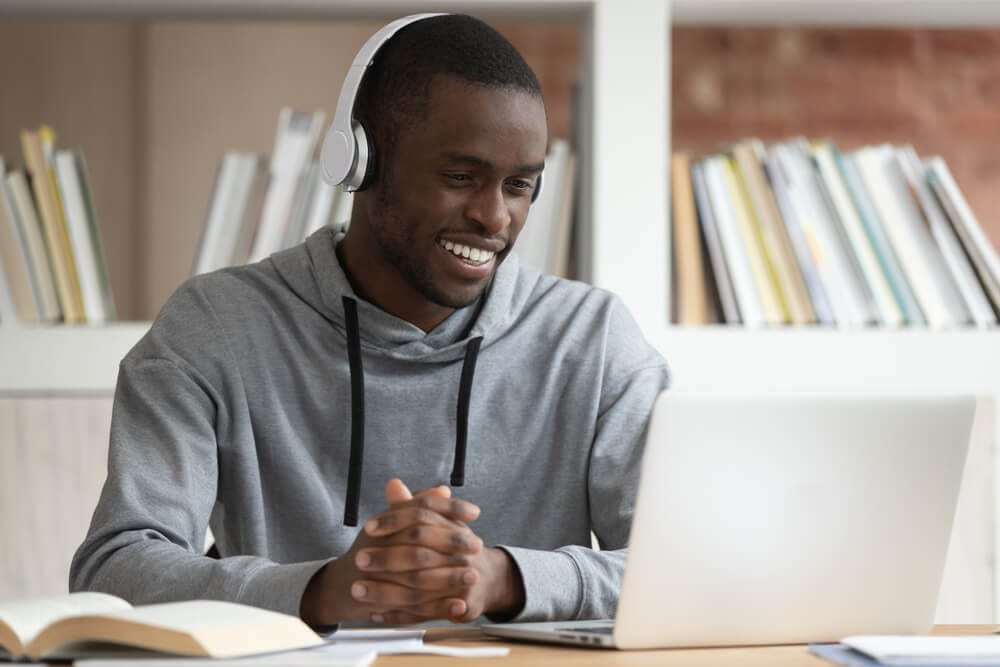 smiling black man watching an online learning course