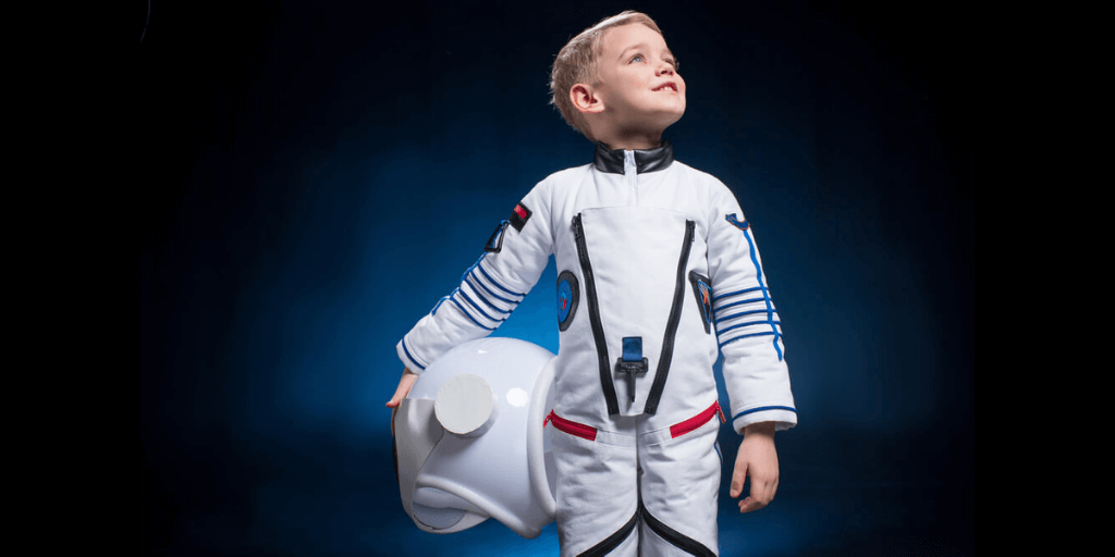 Little boy in a space suit visualizing his astronaut dream job