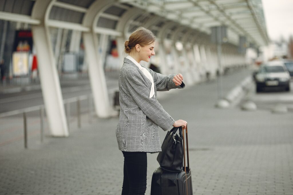 Woman waiting standing with her luggage waiting for her plane