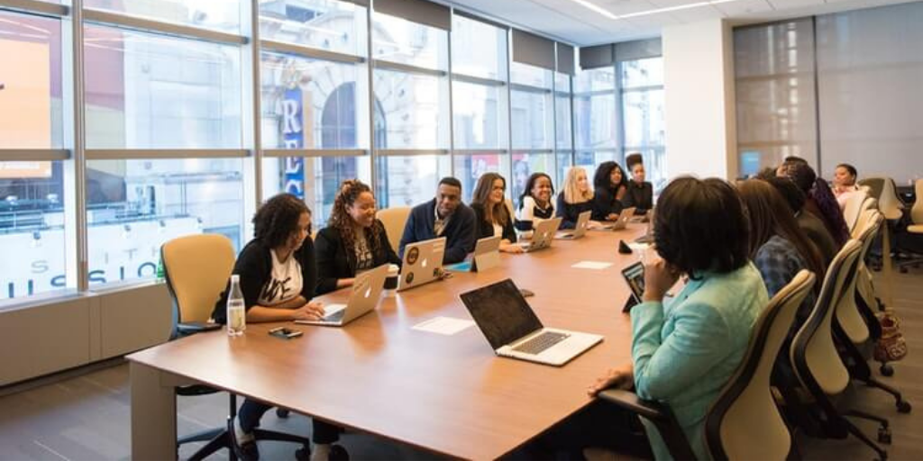 A workplace meeting with a diverse group of employees.