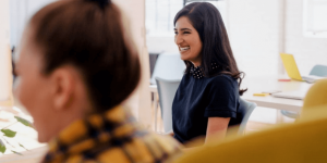 A closeup view of a colleague smiling in the workplace.
