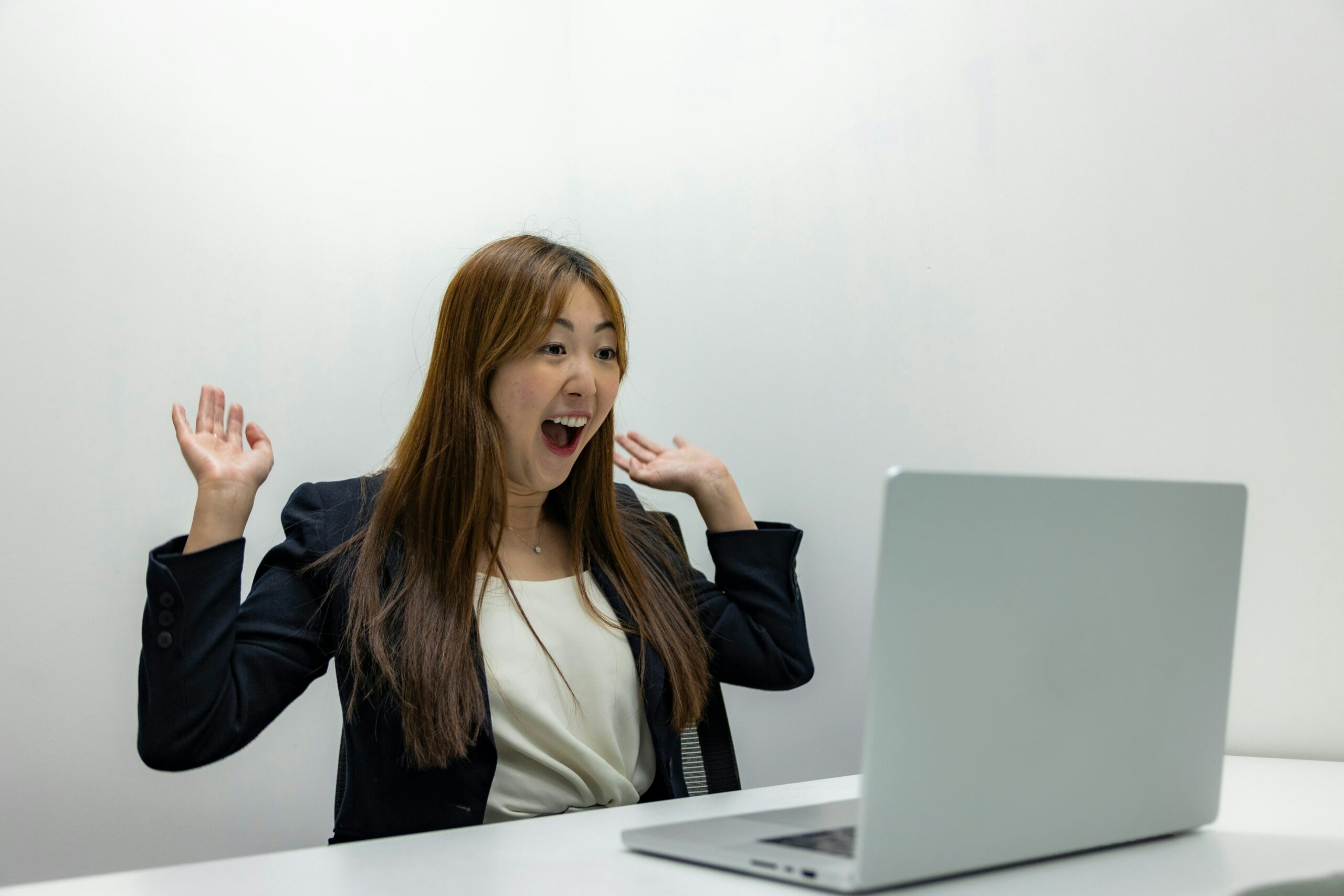 happy woman looking at a laptop